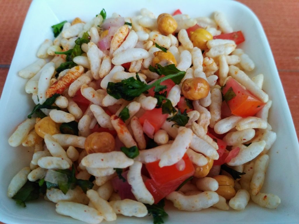 Jhal Muri is a savoury street snack made of puffed rice mixed with a variety of ingredients including onions and chilli. The mixture is served on little paper pouches by street food vendors.